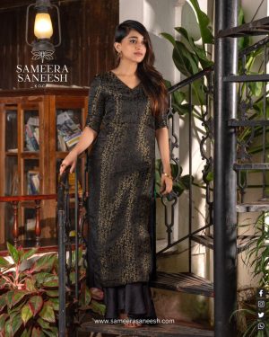 "Midnight Opulence" is an exquisite blend of sophistication and glamour. This ankle-length black kurta features a subtle shimmer that glistens like the night sky, exuding elegance and mystery. The half-sleeve design, combined with a comfortable V-neckline, offers a refined yet modern look,