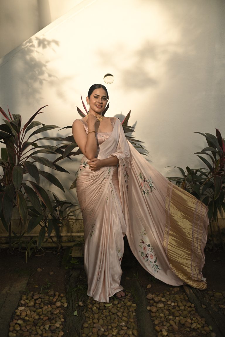 "Blush Silk Reverie" is the epitome of grace and luxury, crafted from a delicate blush-pink silk fabric. This saree drapes beautifully, flowing with soft, elegant pleats and enhanced with intricate embroidery that subtly glimmers with every movement